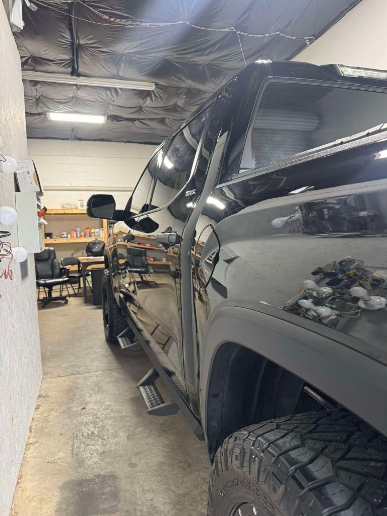 Ceramic-coated black truck with deep gloss reflection
